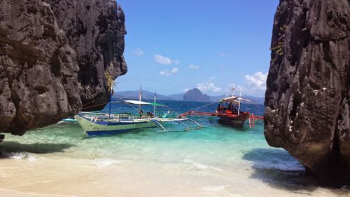 Panoramic view of sea and mountains against blue sky