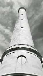 Low angle view of lighthouse against cloudy sky