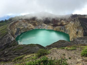 Scenic view of mountains against cloudy sky