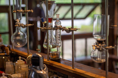 Close-up of glass bottles hanging on table