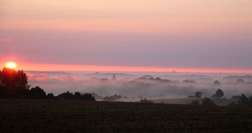 Scenic view of field against sky during sunset