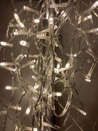 Low angle view of illuminated lighting equipment hanging on ceiling