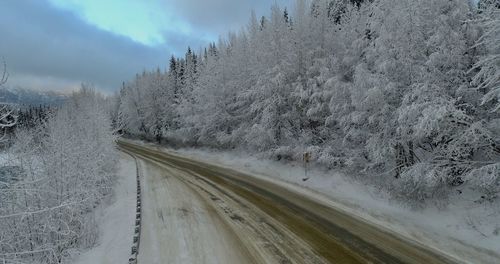 Snow covered road against sky