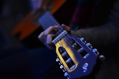 Close-up of hands playing guitar