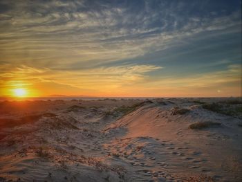 Scenic view of beach against dramatic sky