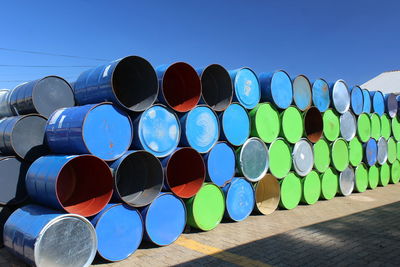 Metallic drum of various colours at a yard of a warehouse 