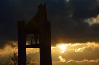 Low angle view of silhouette building against sky during sunset