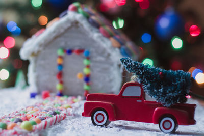 Close-up of gingerbread house with christmas decorations at home