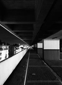 Empty road along bridge at night