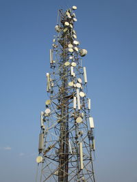 Low angle view of communications tower against sky