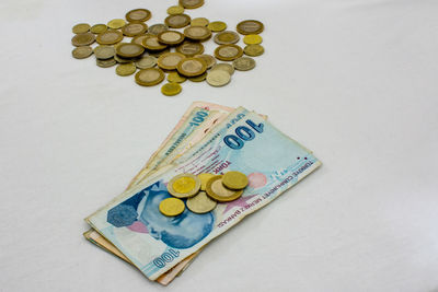 High angle view of coins on white background