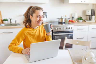 Young woman using laptop at home