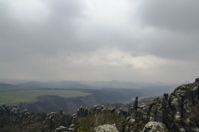 Scenic view of mountains against cloudy sky