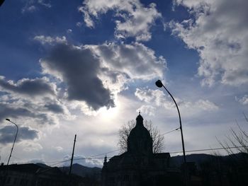 Low angle view of silhouette built structure against sky