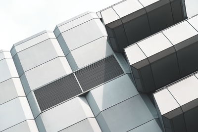 Low angle view of glass building against sky