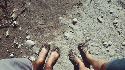 Directly above shot of feet on beach