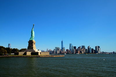 Statue of liberty with city in background