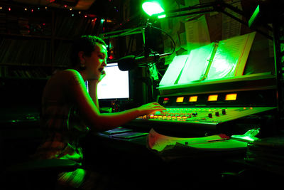 Side view of woman playing at music concert