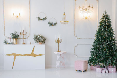 Elegant classic interior of the living room, decorated for christmas and new year in bright colors