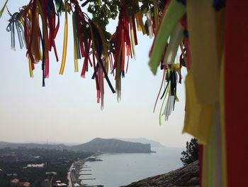 Clothes hanging by sea against clear sky