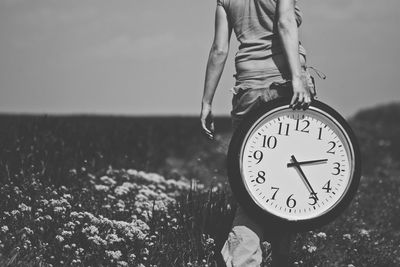 Woman carrying clock