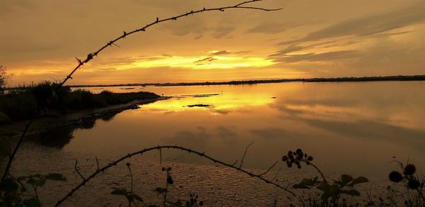 Scenic view of lake against sky during sunset