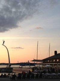 Boats in harbor at sunset