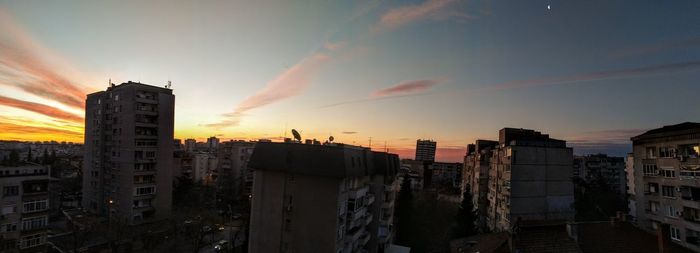 Panoramic view of buildings against sky during sunset