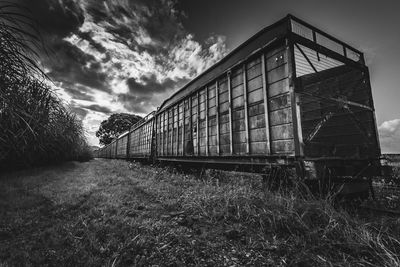 Abandoned train on railroad track against sky