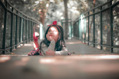 Happy girl sitting on tree