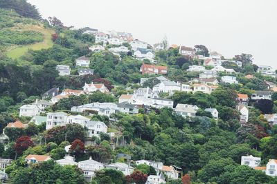 High angle view of buildings in town against clear sky