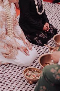 Low section of people sitting at home