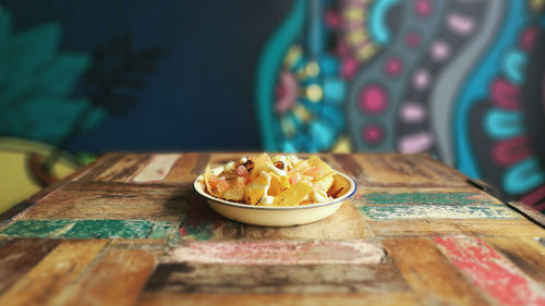 Close-up of dessert on table against wall