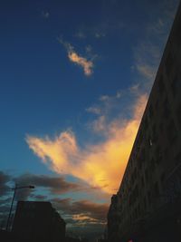 Low angle view of buildings against sky at sunset