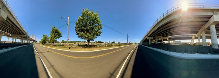 Panoramic view of road against blue sky