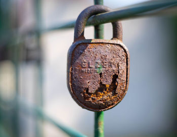 Close-up of padlock on rusty metal