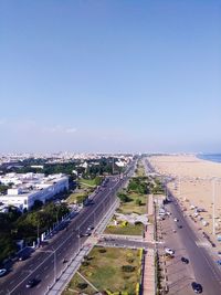 High angle view of city by sea against clear sky