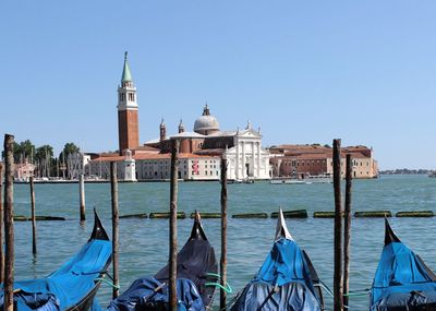 View of church at waterfront against clear sky