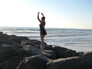 Woman dancing on beach