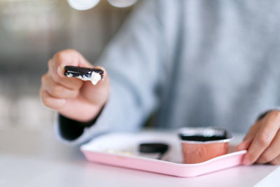 Midsection of man using mobile phone on table