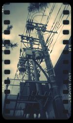 Low angle view of power lines against sky