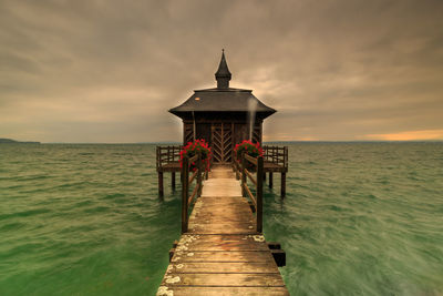 Pier over sea against sky