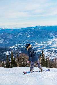 Full length of man on snowboarding during winter