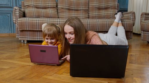 Midsection of woman using laptop at table