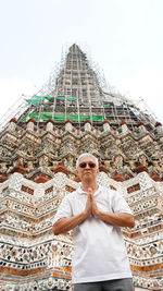Portrait of man standing against temple
