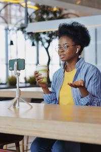 Young woman sitting on table