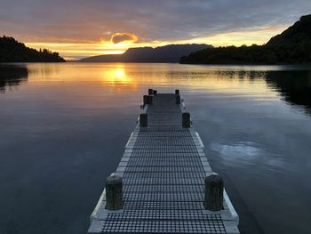 Scenic view of lake against orange sky, lake tarawera new zealand 