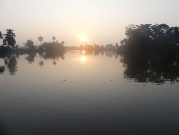 Scenic view of lake against sky during sunset