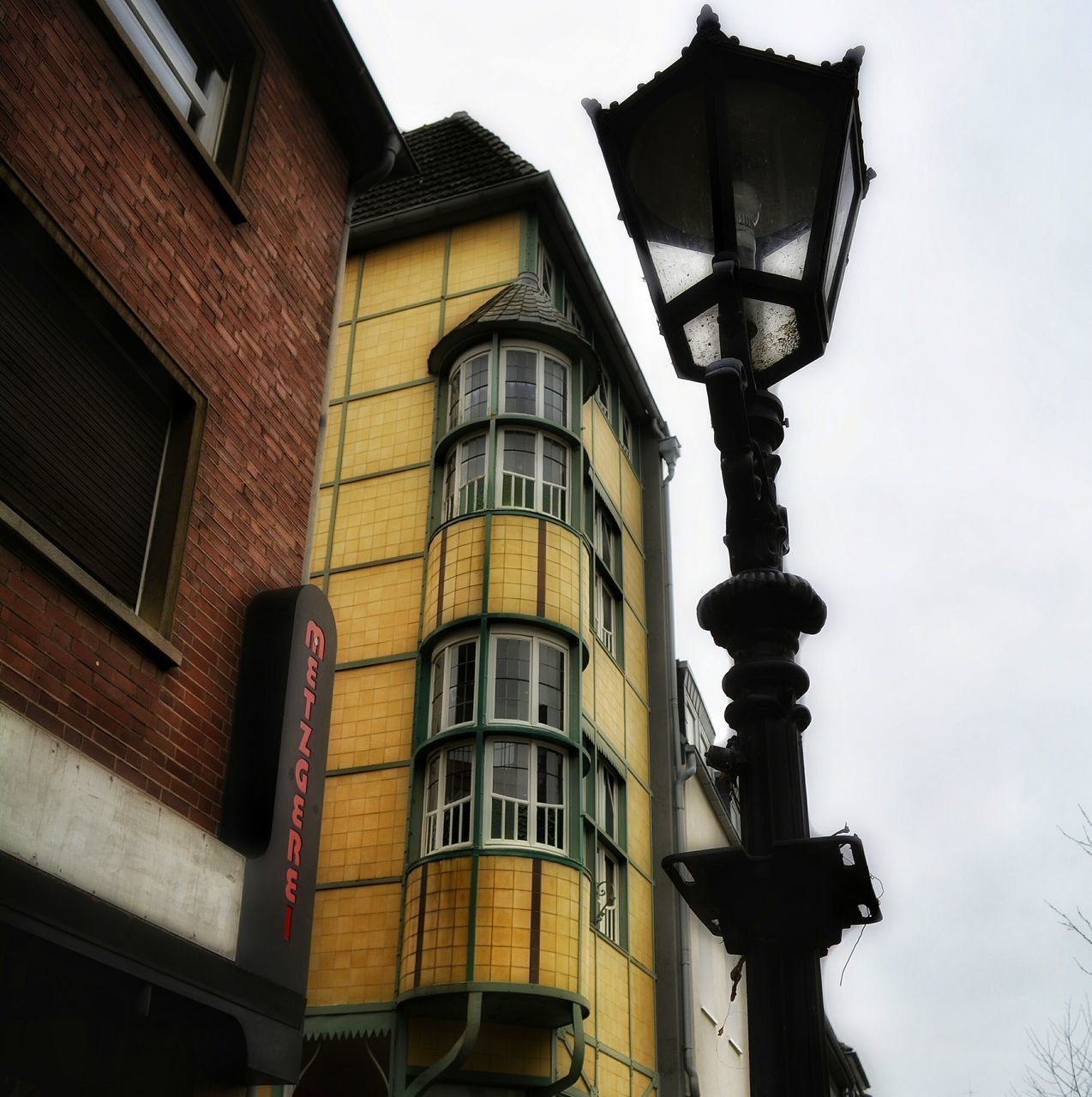 architecture, building exterior, built structure, low angle view, window, residential building, building, residential structure, balcony, house, sky, clear sky, facade, no people, day, outdoors, in a row, street light, city, exterior