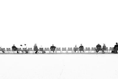 Silhouette people standing against clear sky